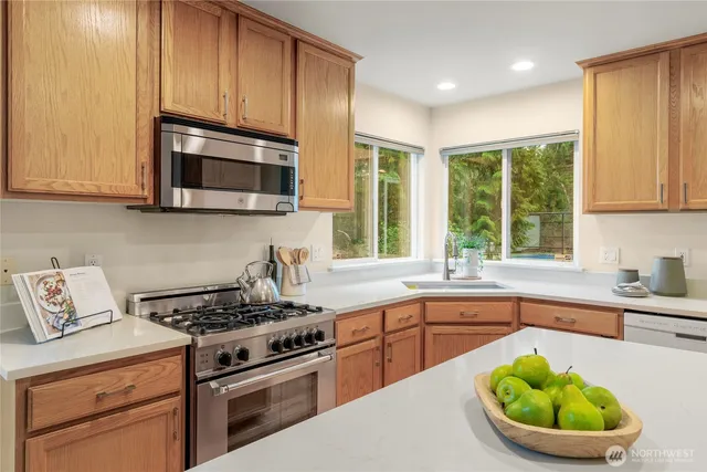 a kitchen with a stove a sink and a microwave