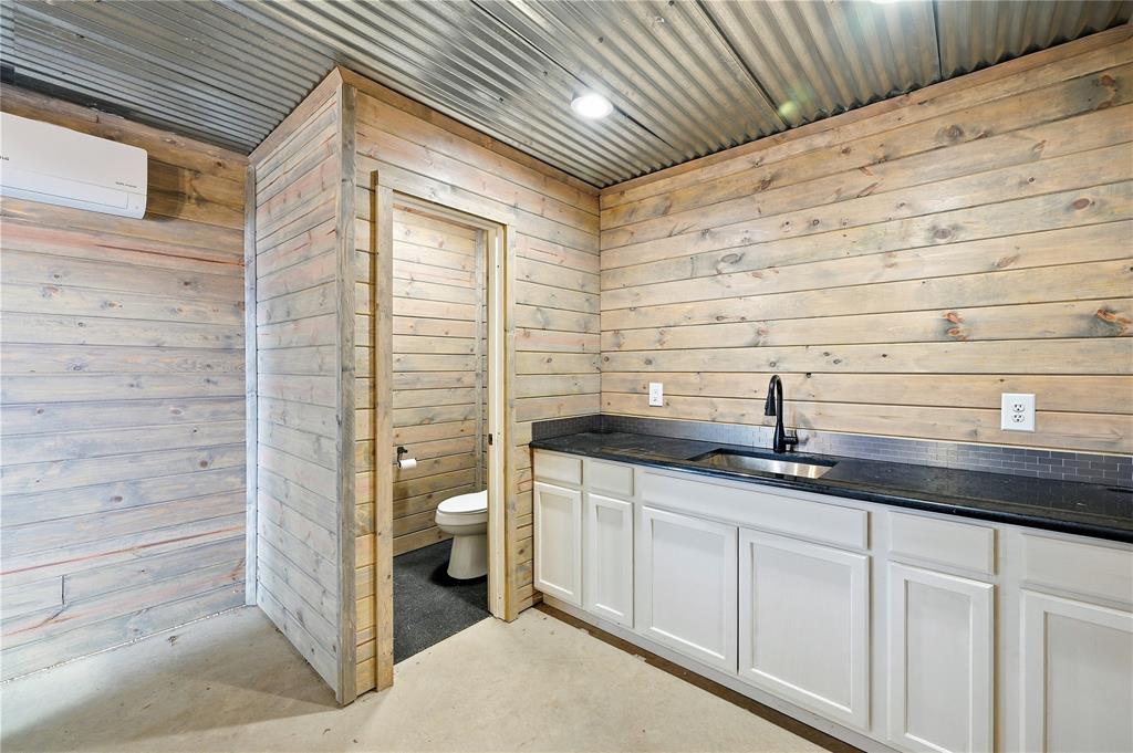 1807 Pink Hill Road Bells, TX 75414 - Photo 20 of 31 a bathroom with a granite countertop sink a toilet and shower