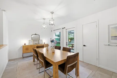 a view of a dining room with a table and chairs