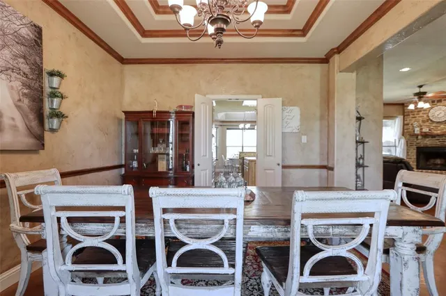 a view of a dining room with furniture and chandelier