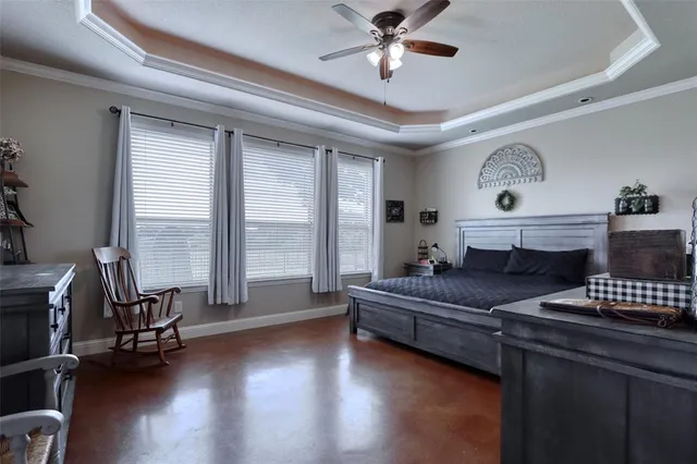 a bedroom with a bed and a large window