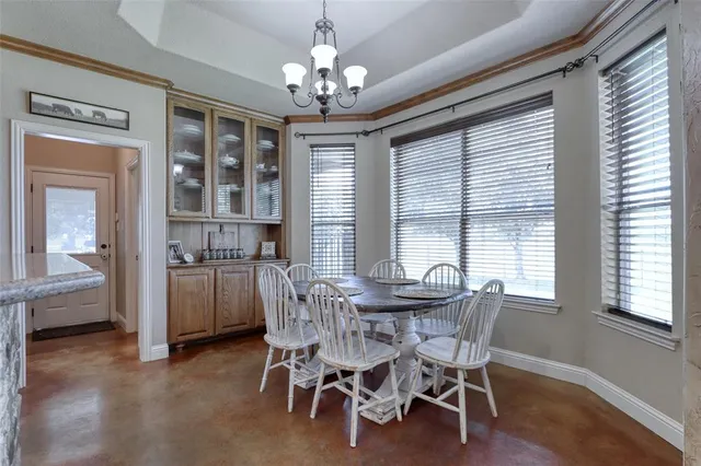 a view of a dining room with furniture and window