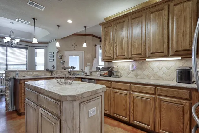 a kitchen with a sink cabinets and wooden floor
