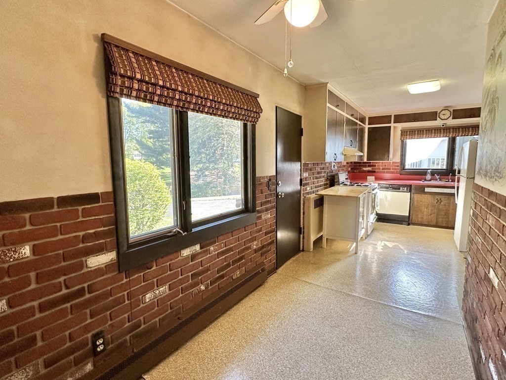 44 Hampton Knolls Road Holyoke, MA 01040 - Photo 12 of 42 a living room with furniture a flat screen tv and a floor to ceiling window