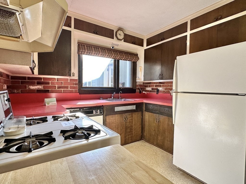 44 Hampton Knolls Road Holyoke, MA 01040 - Photo 13 of 42 a kitchen with a refrigerator and a stove