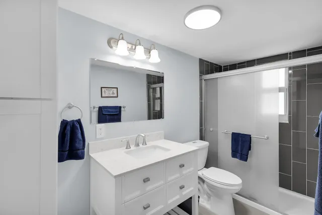 a bathroom with a sink toilet and shower