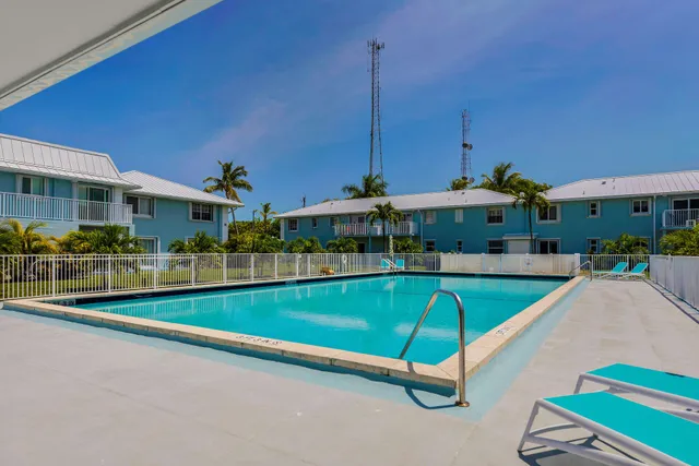 a view of a swimming pool with outdoor seating