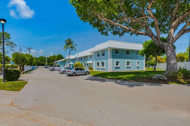 a view of a street with a building and a street sign