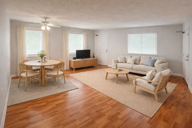 a view of a hallway with wooden floor and closet