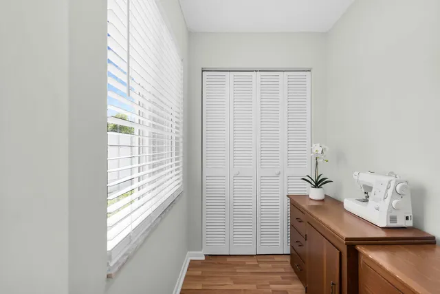 a living room with furniture a flat screen tv and a window