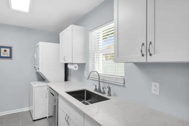 a kitchen with white cabinets and a sink