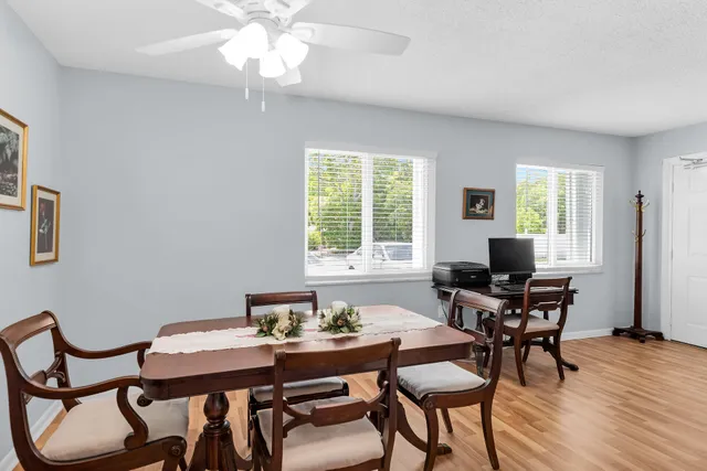 a view of a dining room with furniture and wooden floor