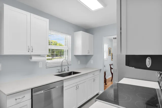 a dining room with furniture and a floor to ceiling window