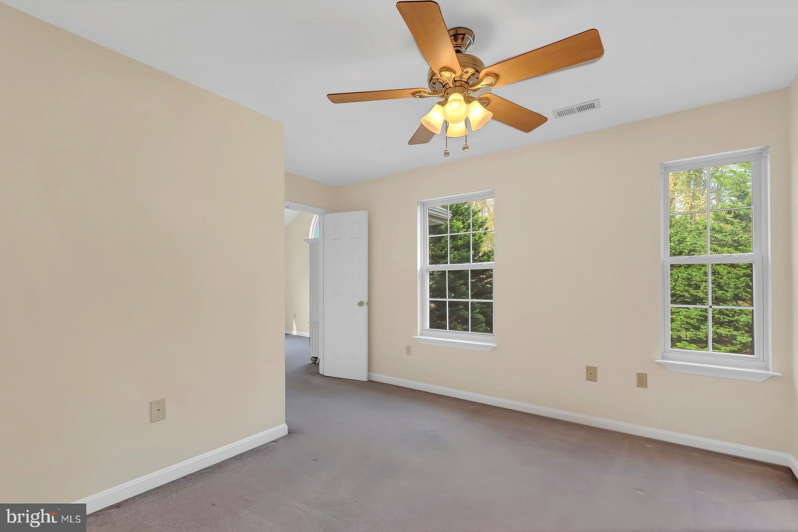 6815 Mackall Road St. Leonard, MD 20685 - Photo 25 of 38 an empty room with windows and fan