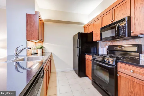 a kitchen with stainless steel appliances a stove a sink and a microwave