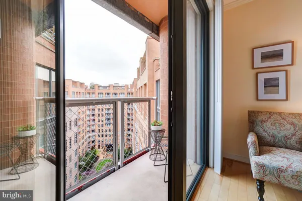 a view of a balcony with furniture and city view