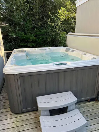a view of a wooden floor and trees in the background
