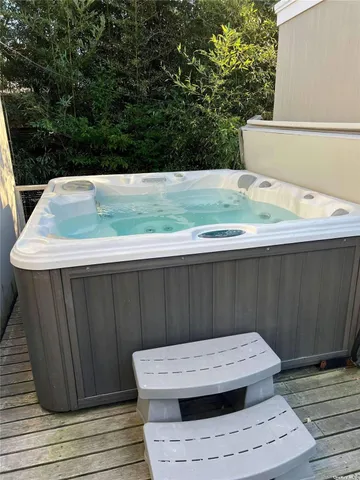 a view of a wooden floor and trees in the background