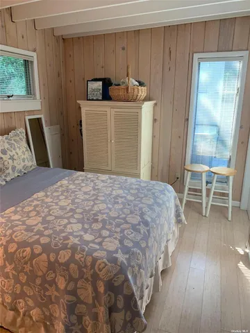 a bedroom with a bed and a chair