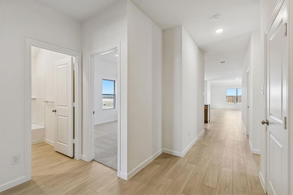 3820 Prairie Chapel Road Royse City, TX 75189 - Photo 2 of 18 a view of a hallway with wooden floor and a bathroom