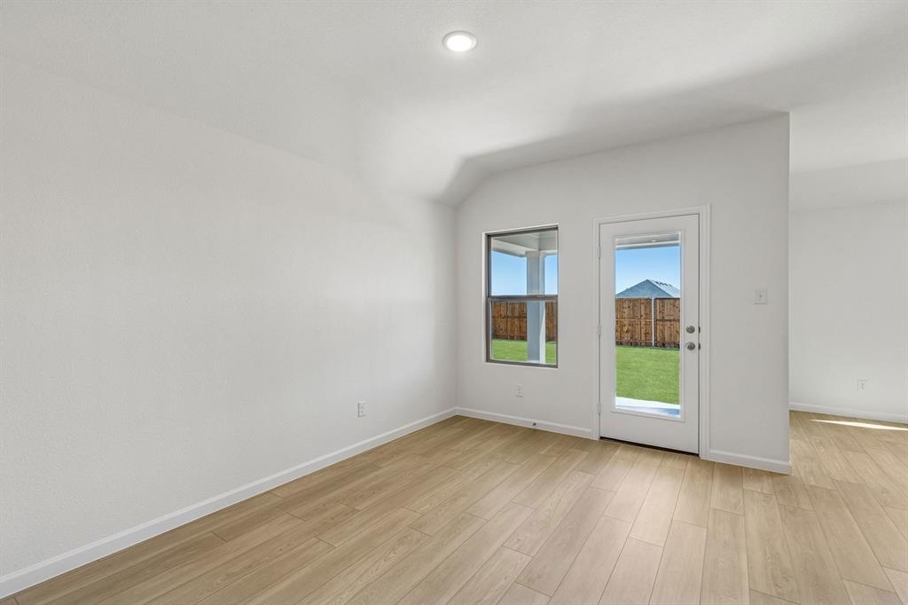 3820 Prairie Chapel Road Royse City, TX 75189 - Photo 5 of 18 an empty room with wooden floor and windows