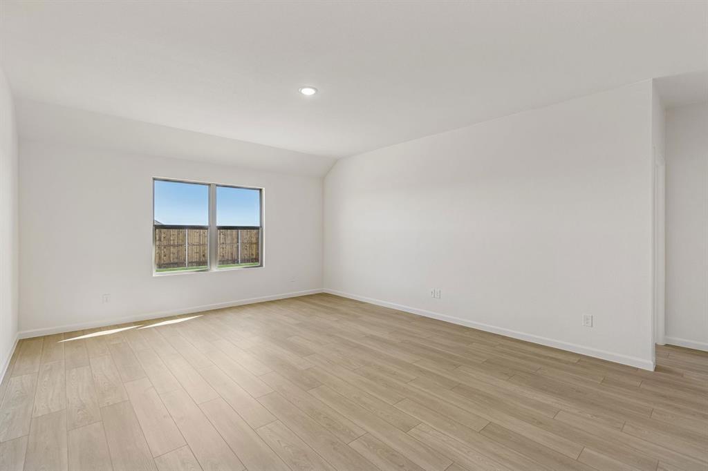 3820 Prairie Chapel Road Royse City, TX 75189 - Photo 6 of 18 a view of empty room with wooden floor and fan