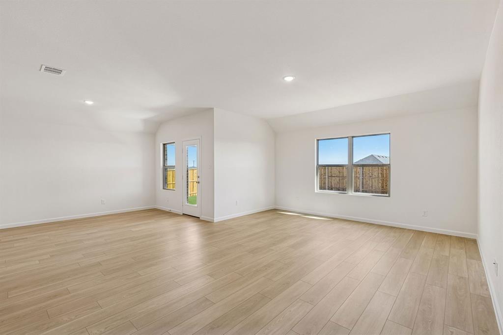 3820 Prairie Chapel Road Royse City, TX 75189 - Photo 8 of 18 an empty room with wooden floor and windows