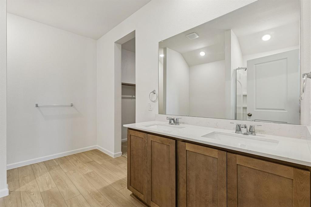 3820 Prairie Chapel Road Royse City, TX 75189 - Photo 10 of 18 a bathroom with a double vanity sink and mirror
