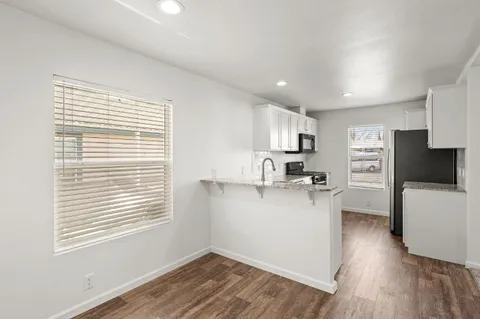 a view of a kitchen with a sink and a refrigerator