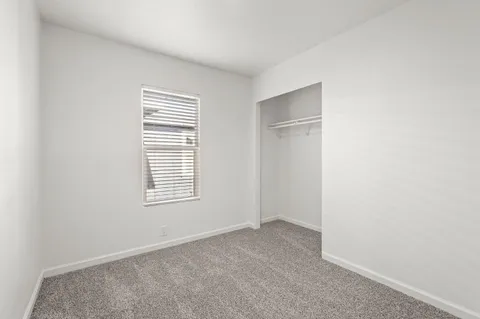 a bedroom with bed and a window