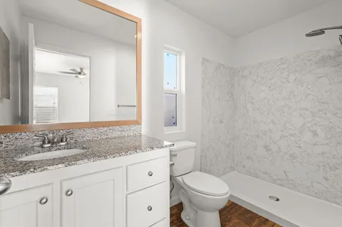 a white toilet sitting next to a bath tub