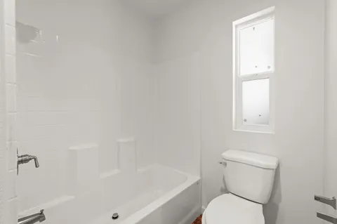 a view of a hallway with seating space