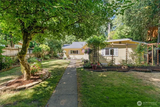 a front view of a house with a yard and trees