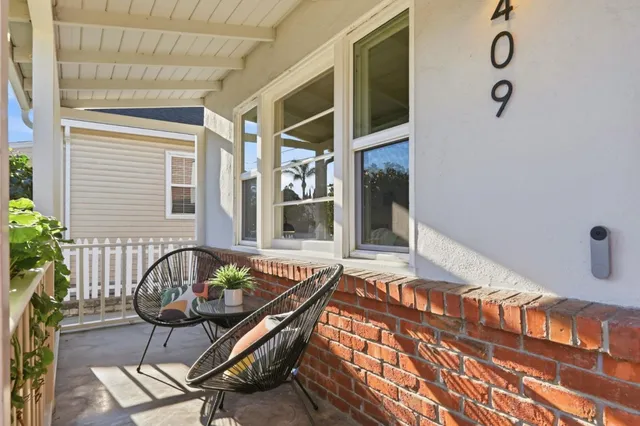 a balcony with furniture and a potted plant