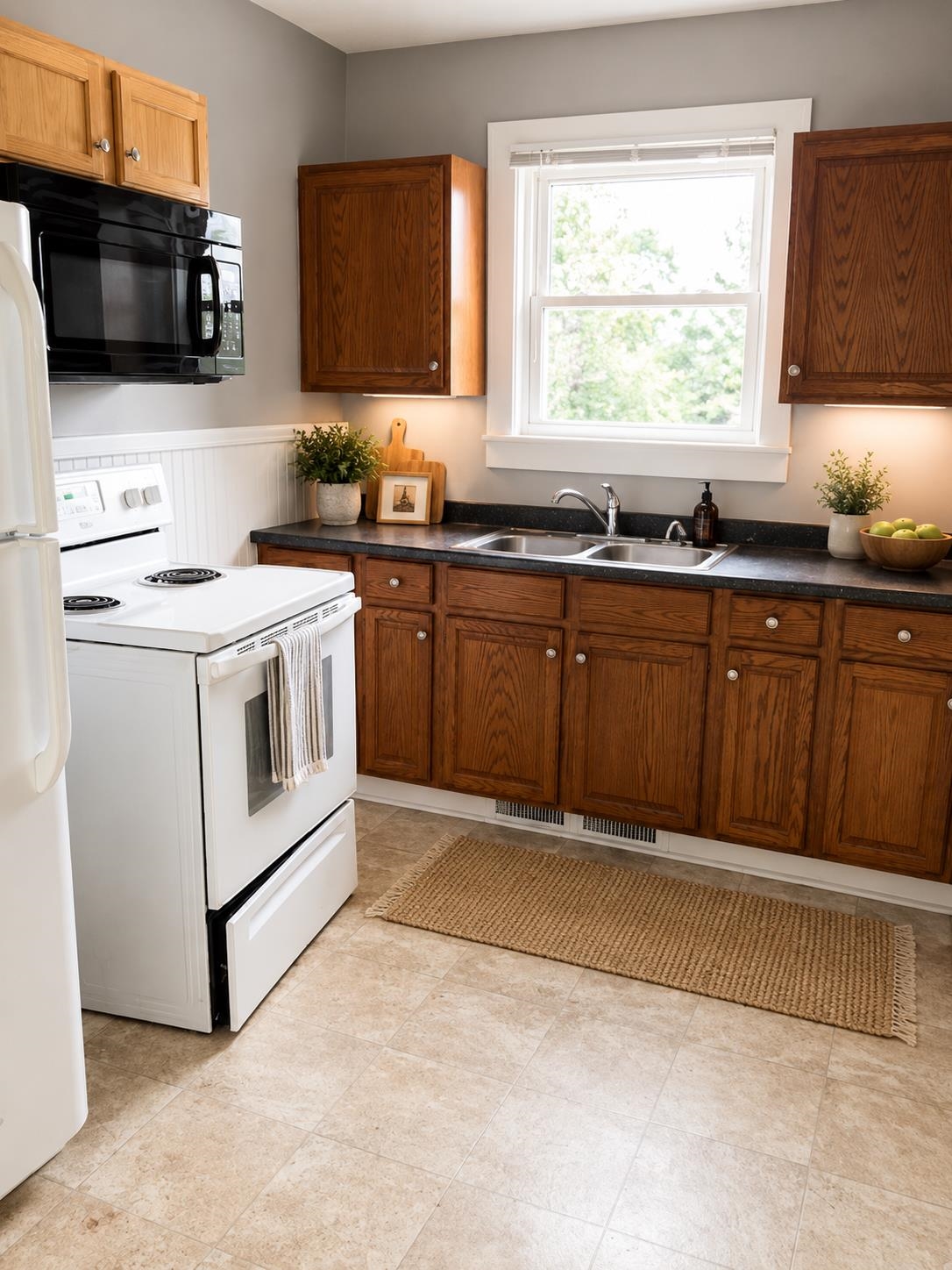 613 Alpha Street Waynesboro, VA 22980 - Photo 7 of 16 a kitchen with stainless steel appliances granite countertop a stove a sink and a microwave