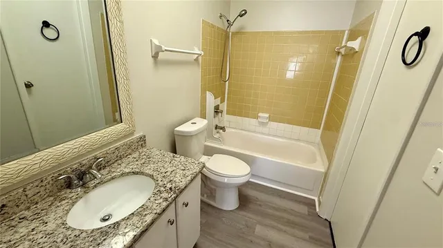 a view of a balcony with wooden floor and fence