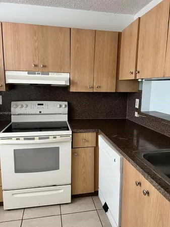 a kitchen with a stove and a sink