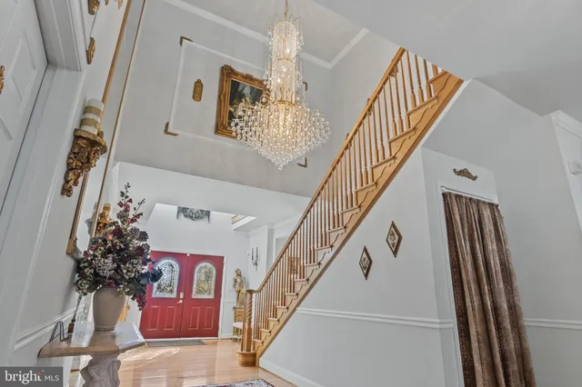 a dining room with furniture wooden floor a rug and a chandelier