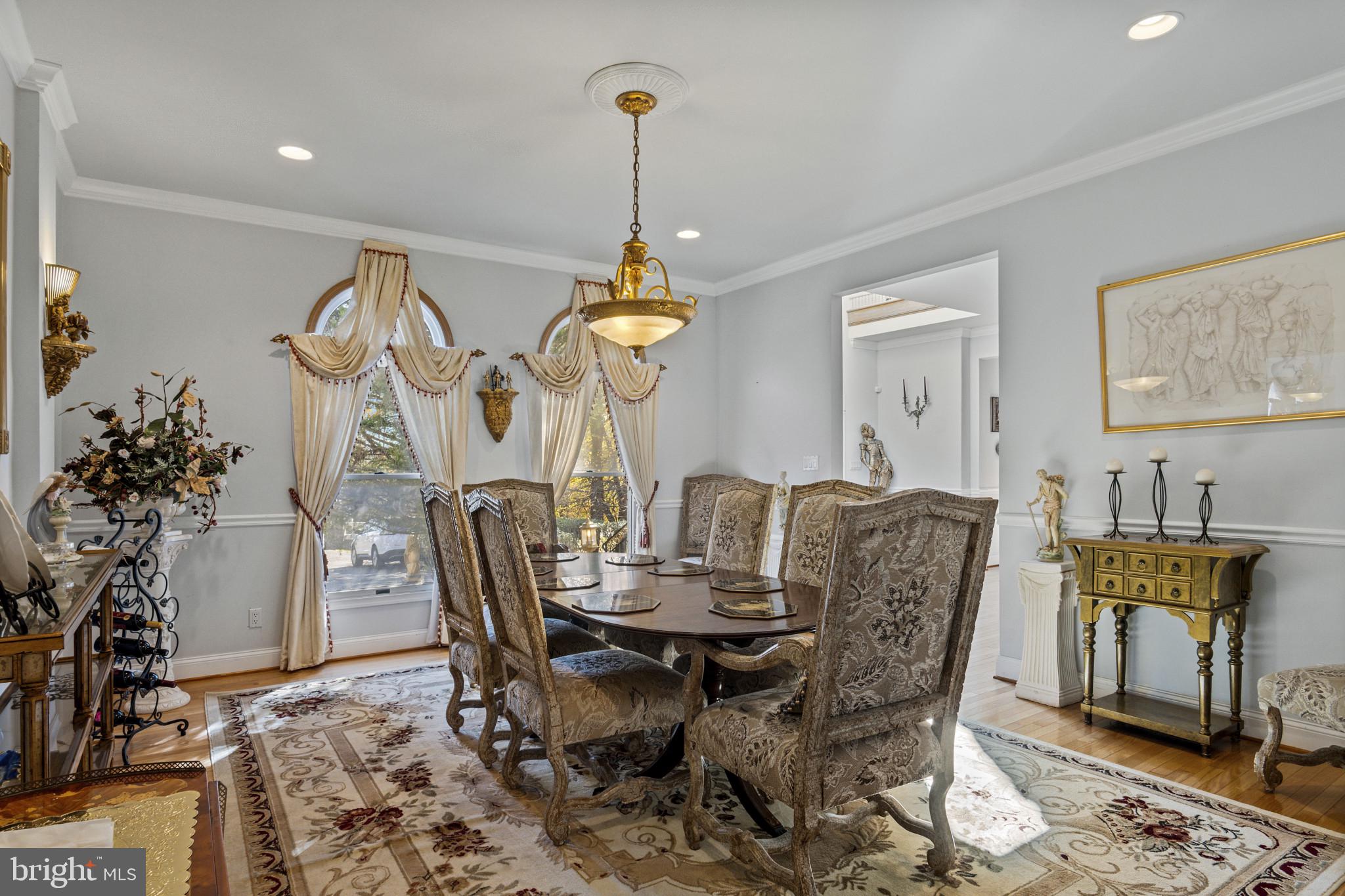 10900 Sunset Hills Road Reston, VA 20190 - Photo 16 of 62 a dining room with furniture potted plants and wooden floor