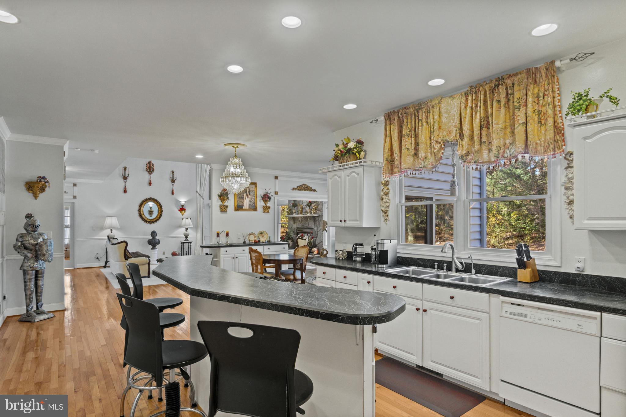 10900 Sunset Hills Road Reston, VA 20190 - Photo 30 of 62 a kitchen with granite countertop a sink and cabinets