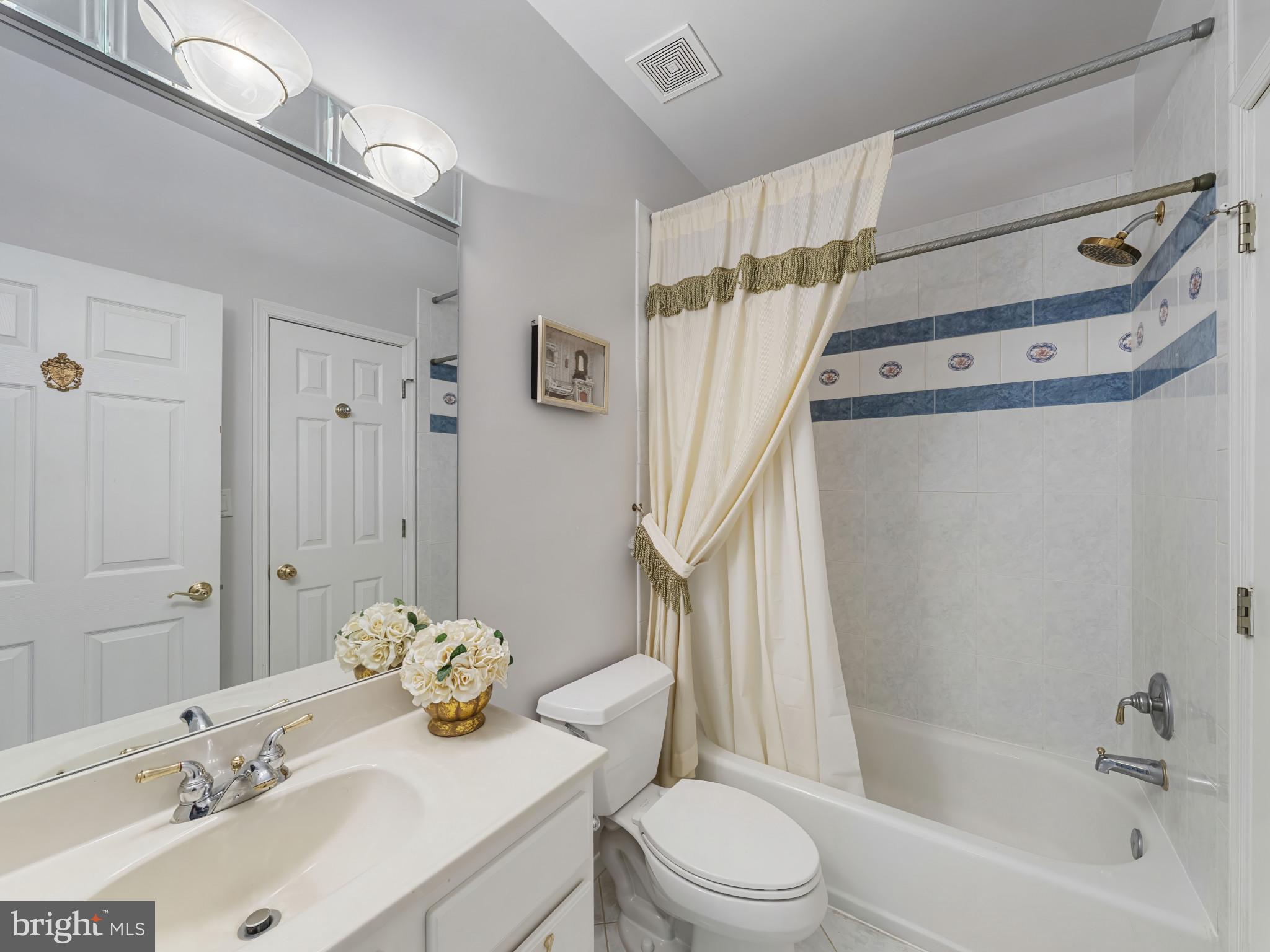 10900 Sunset Hills Road Reston, VA 20190 - Photo 39 of 62 a bathroom with a sink mirror vanity and toilet