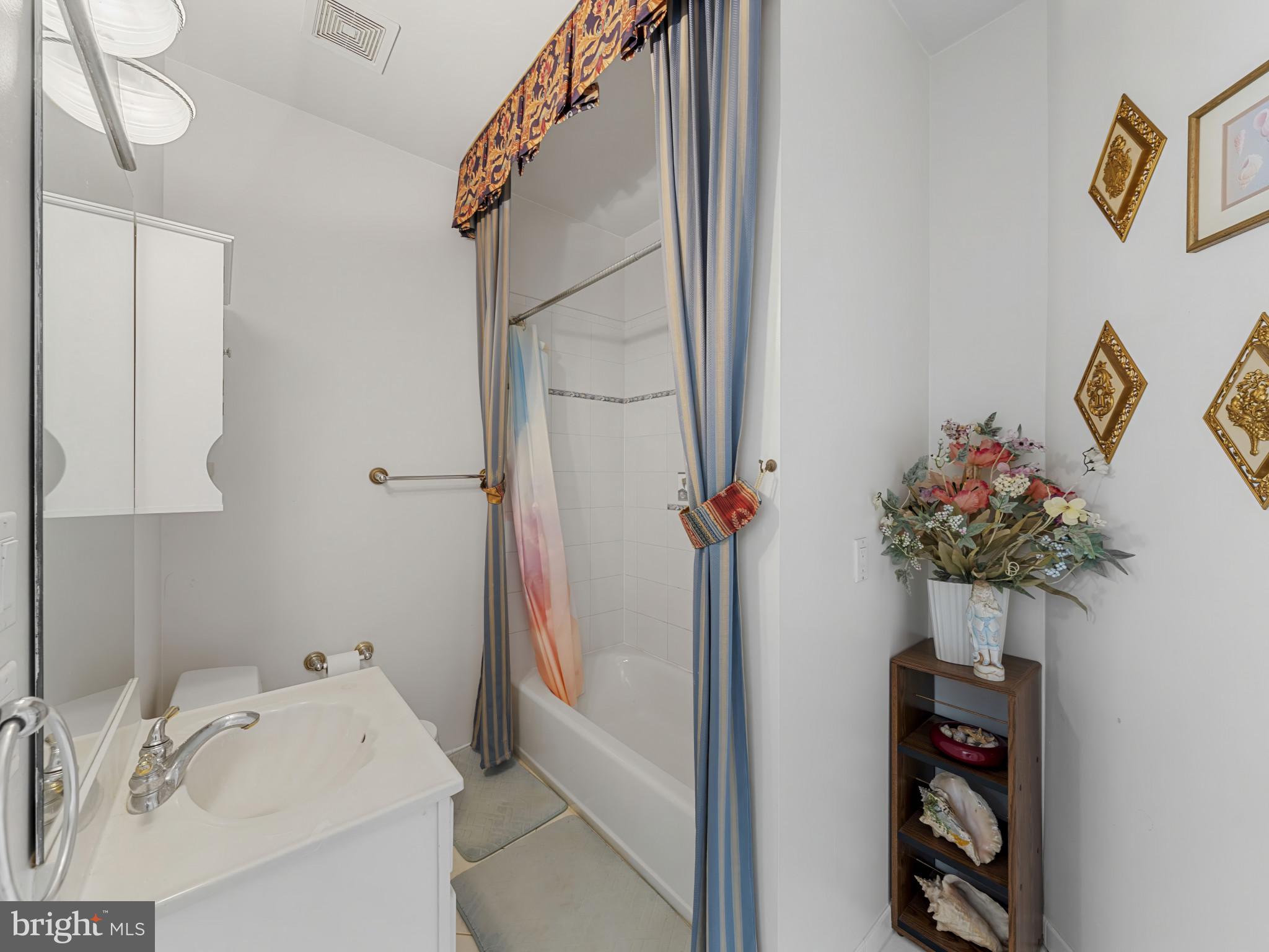 10900 Sunset Hills Road Reston, VA 20190 - Photo 41 of 62 a bathroom with a sink and a mirror