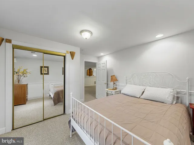 a large white kitchen with stainless steel appliances granite countertop a sink and cabinets