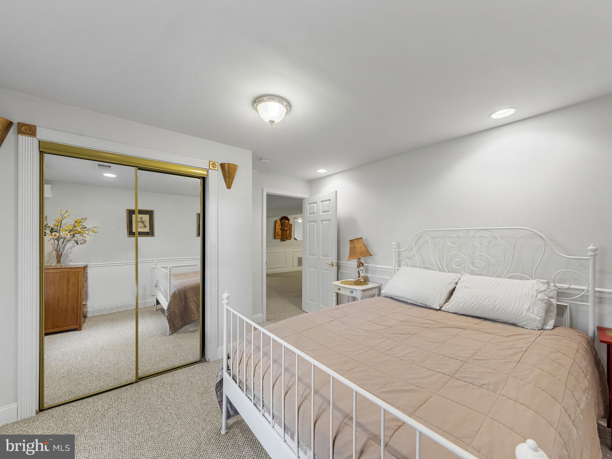 10900 Sunset Hills Road Reston, VA 20190 - Photo 49 of 62 a bedroom with a large bed and a walk in closet