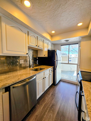 5265 South Rome Beauty Park Murray, UT 84123 - Photo 22 of 35 Kitchen with recessed lighting, stainless steel dishwasher, dark wood-style floors, white cabinets, and electric range oven