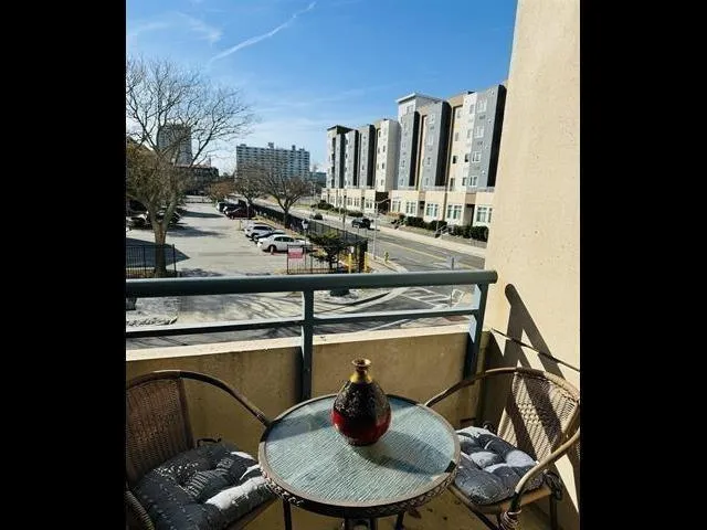 a view of hallway with stairs and wooden floor