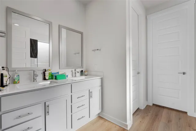 a kitchen with white cabinets and sink