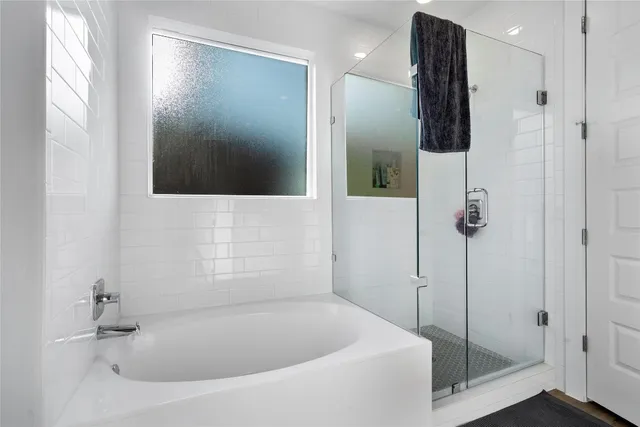 a bathroom with a tub and shower