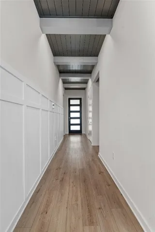 a view of empty room with wooden floor