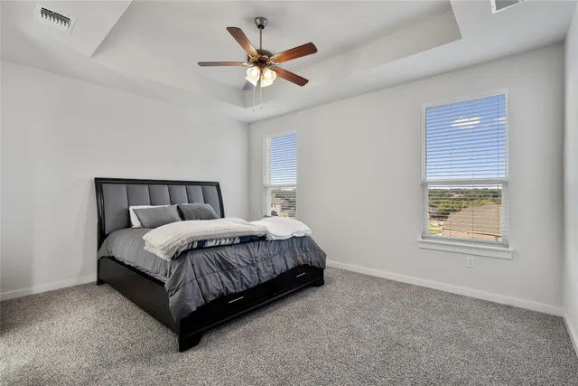 a bedroom with a large bed and a window